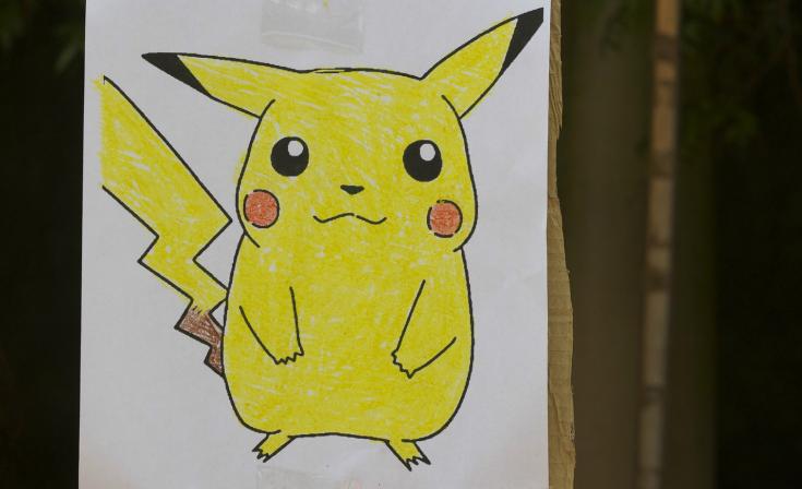 A drawing of Pikachu taped up on a pole